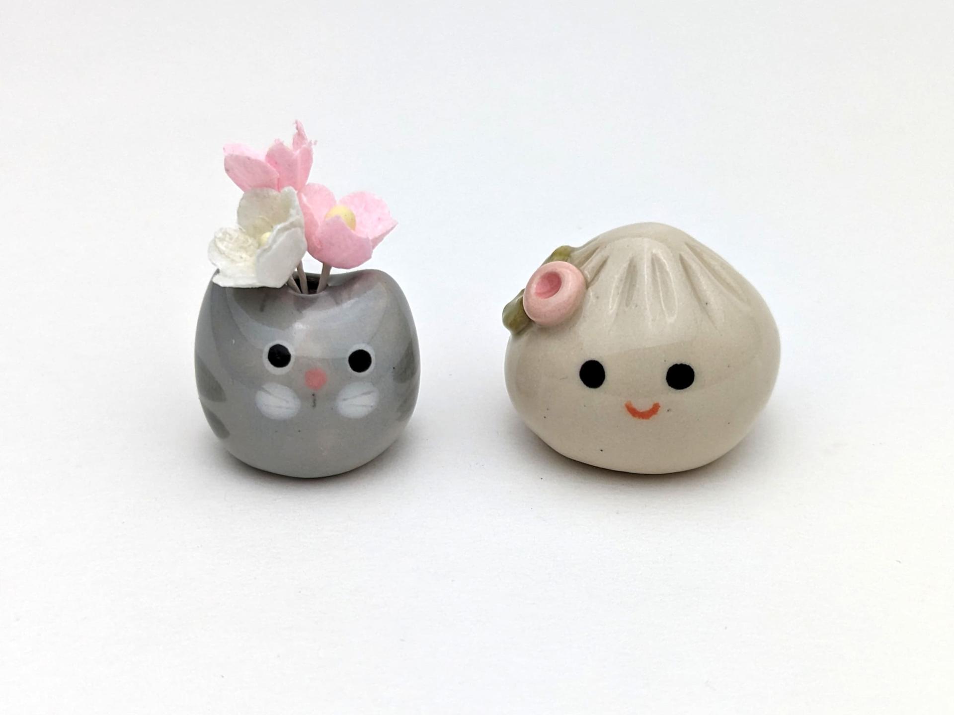 Two cute handmade ceramic dumplings - One with flower. Happy soup dumplings. Xiao long bao. Small-batch ceramics. Hand-painted pottery.
