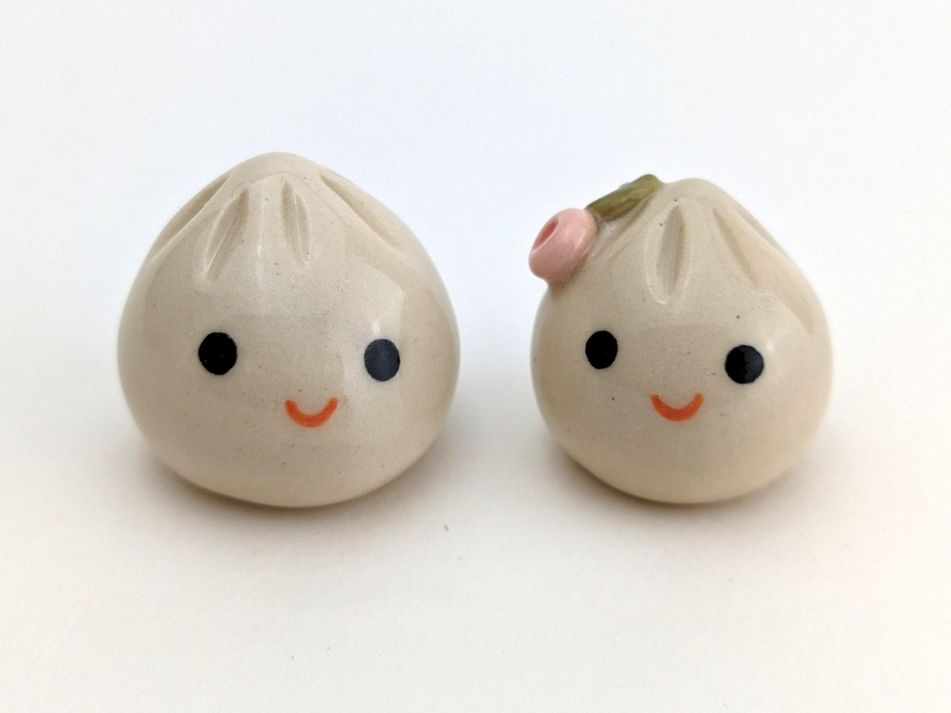 Two cute handmade ceramic dumplings - One with flower. Happy soup dumplings. Xiao long bao. Small-batch ceramics. Hand-painted pottery.